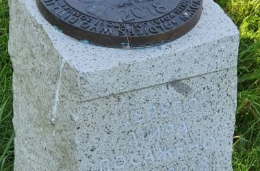 A memorial pillar next to the Tree of Peace